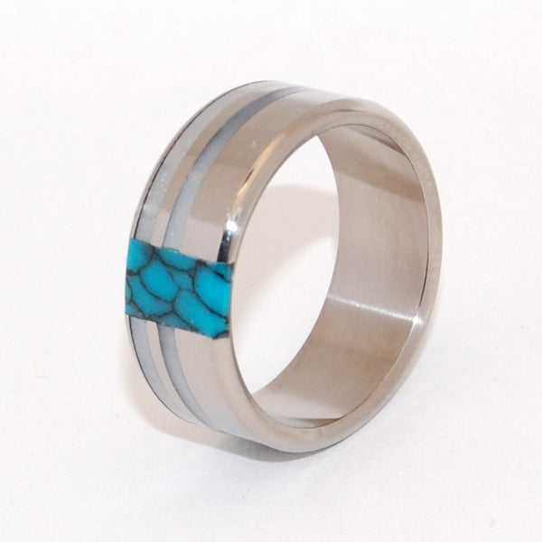 Innocent. Twin bands of glowing gray marbled opalescent are offset by turquoise, stunning against a titanium backdrop. A design well-suited for wider bands. Pictured at 9.5mm. 