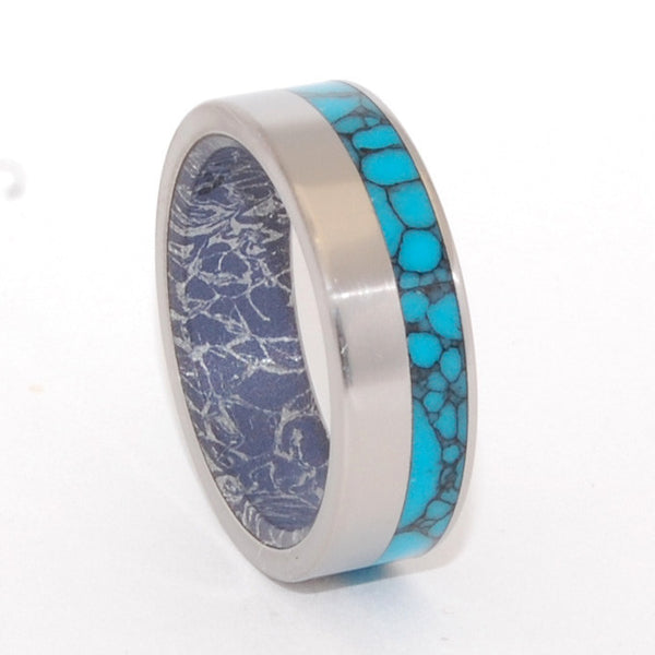 This beautifully crafted, titanium wedding ring has an exterior offset inlay of Arizona webbed Turquoise and an interior overlay of Blue Silver M3 Mokume. The aqua rich hue and contrasting graphite tone of the Blue Silver M3 Mokume gives this band a modern appeal. Nicely polished with a mirror finish and flat edges. Pictured at 8mm.