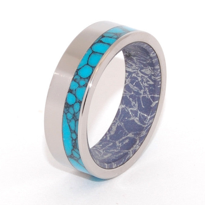 This beautifully crafted, titanium wedding ring has an exterior offset inlay of Arizona webbed Turquoise and an interior overlay of Blue Silver M3 Mokume. The aqua rich hue and contrasting graphite tone of the Blue Silver M3 Mokume gives this band a modern appeal. Nicely polished with a mirror finish and flat edges. Pictured at 8mm.